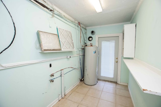 clothes washing area with a textured ceiling, crown molding, laundry area, water heater, and light tile patterned floors