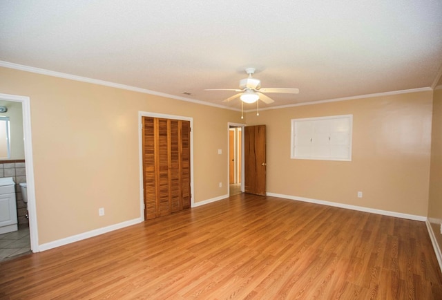 unfurnished room with baseboards, ceiling fan, ornamental molding, and light wood finished floors