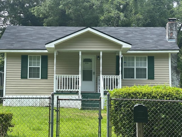 313 Felix St, Thomasville, GA 31792 - view of front facade featuring covered porch, a fenced front yard, a gate, and a chimney