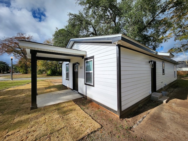 view of home's exterior featuring a carport