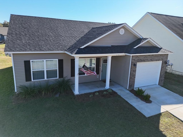 view of front of home with a garage and a front lawn