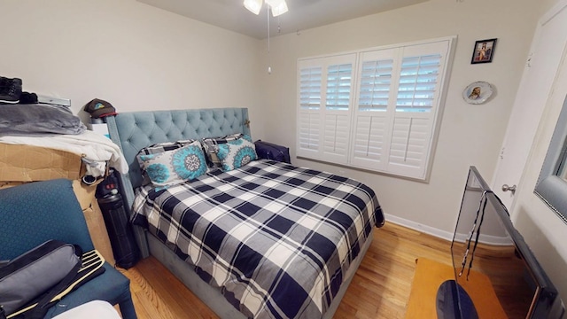 bedroom with light wood-style flooring and baseboards