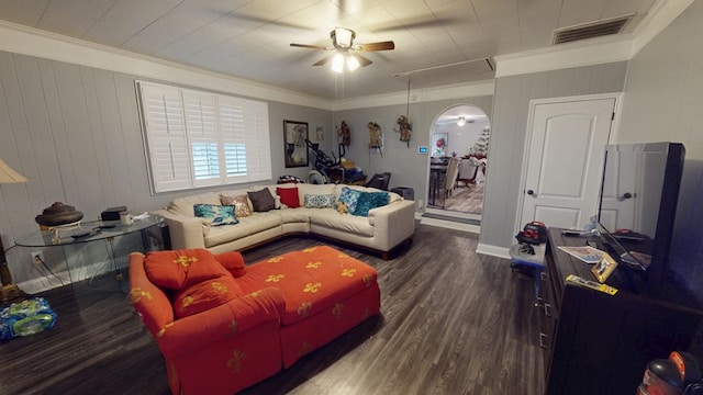 living room featuring visible vents, arched walkways, a ceiling fan, dark wood-type flooring, and crown molding