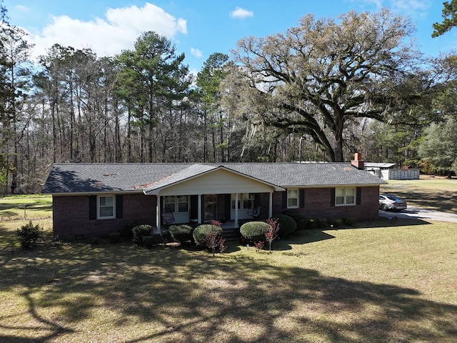 single story home featuring a porch, brick siding, crawl space, a front lawn, and a chimney