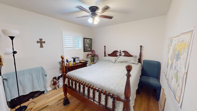 bedroom with a ceiling fan and wood finished floors