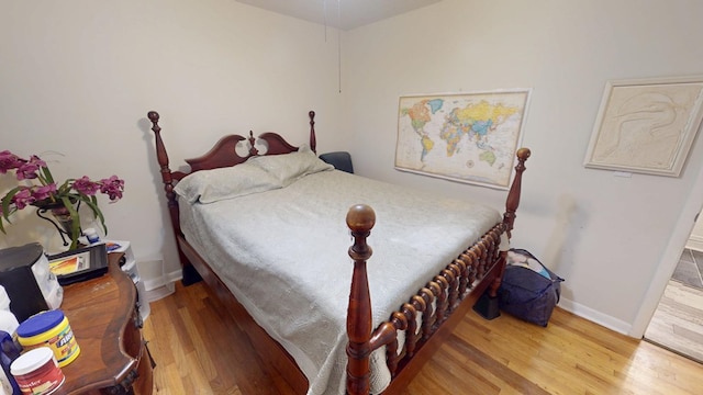 bedroom with wood finished floors and baseboards