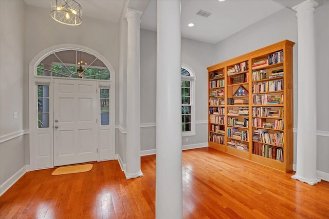 entryway featuring hardwood / wood-style floors, recessed lighting, baseboards, ornate columns, and visible vents