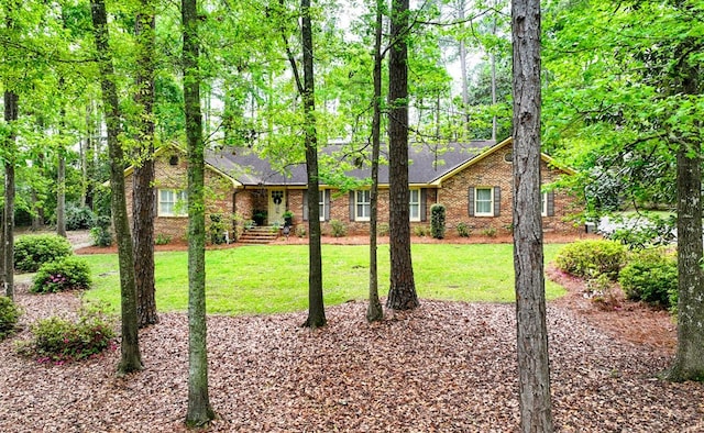 232 Cherokee Cir, Thomasville, GA 31757 - view of front of home with brick siding, a front lawn, and a shingled roof