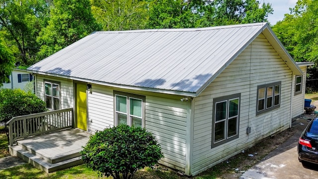 460 SW 2nd St, Cairo, GA 39828 - rear view of house with metal roof and a wooden deck