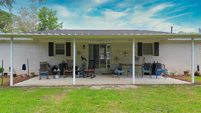 611 Patterson Still Rd, Thomasville, GA 31792 - back of house with brick siding, a lawn, and a patio