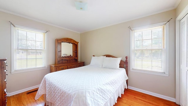 611 Patterson Still Rd, Thomasville, GA 31792 - bedroom with light wood-style flooring, baseboards, crown molding, and multiple windows