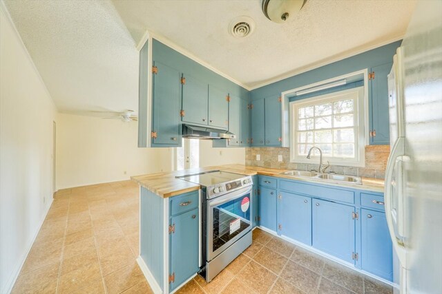 kitchen with stainless steel electric stove, sink, decorative backsplash, white refrigerator, and a textured ceiling