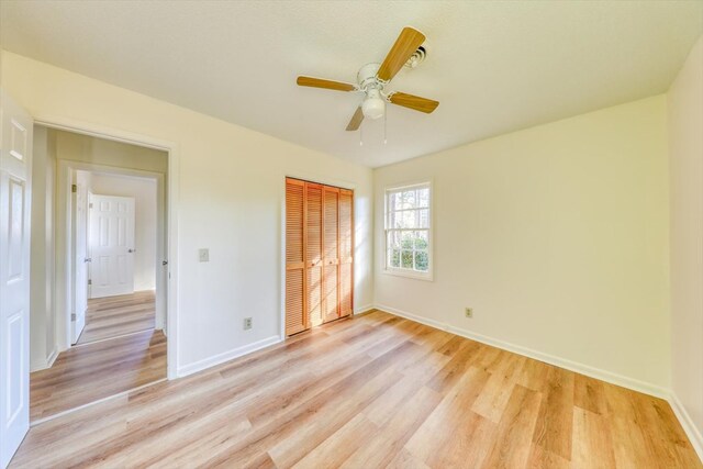 unfurnished bedroom featuring a closet, ceiling fan, and light hardwood / wood-style flooring