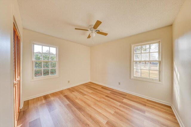 empty room featuring ceiling fan, light hardwood / wood-style floors, and a textured ceiling