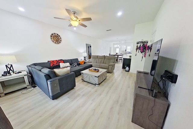 living room with ceiling fan and light hardwood / wood-style floors