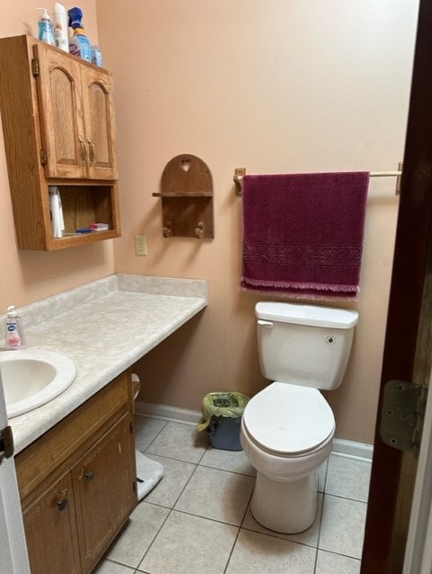 bathroom featuring vanity, tile patterned floors, and toilet