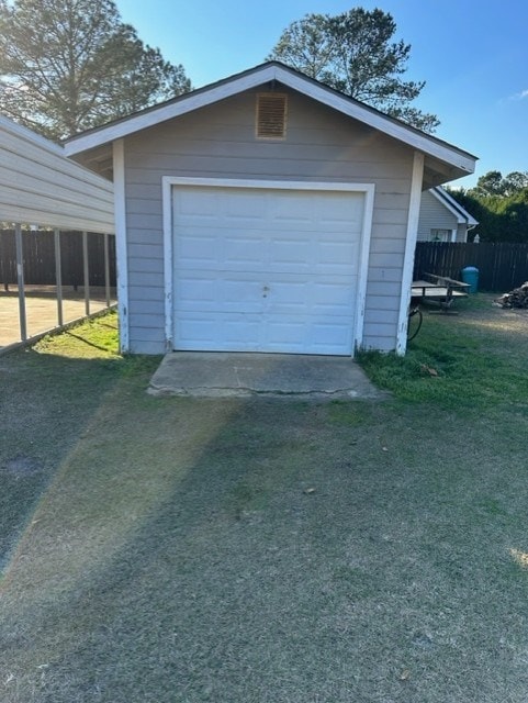 garage featuring a lawn