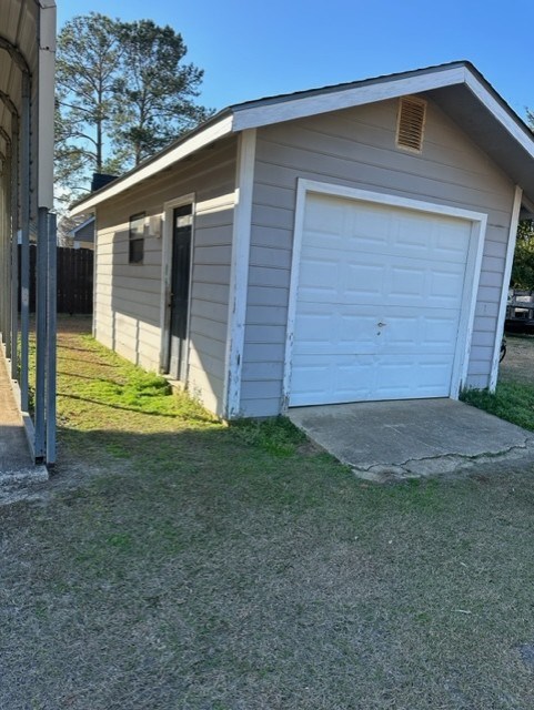 garage with a lawn