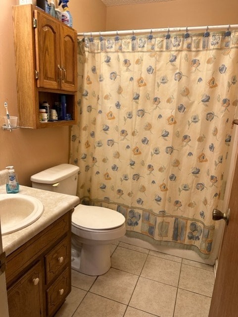 full bathroom with tile patterned flooring, vanity, a textured ceiling, toilet, and shower / bath combo with shower curtain