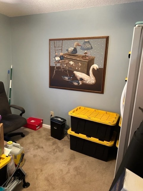 bedroom featuring white fridge, carpet floors, and a textured ceiling