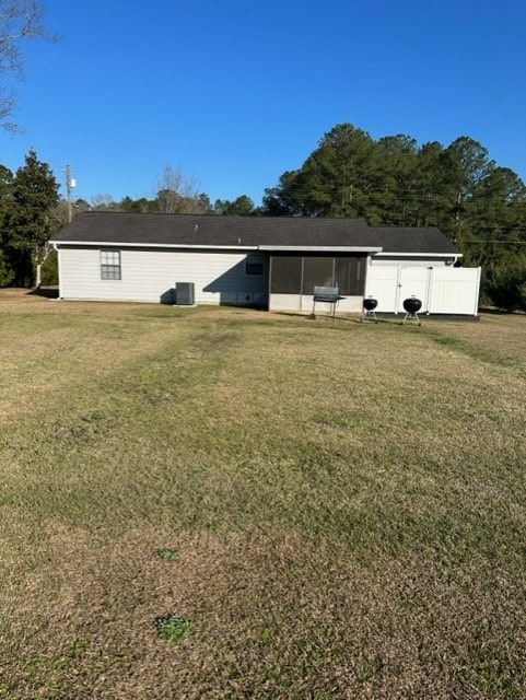 rear view of property with a lawn