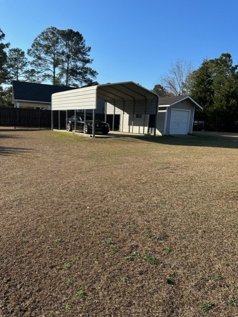 exterior space featuring a carport, a garage, and a lawn