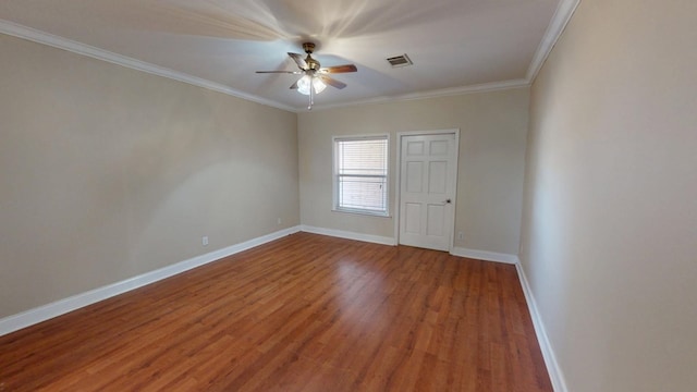 empty room with ornamental molding, hardwood / wood-style floors, and ceiling fan