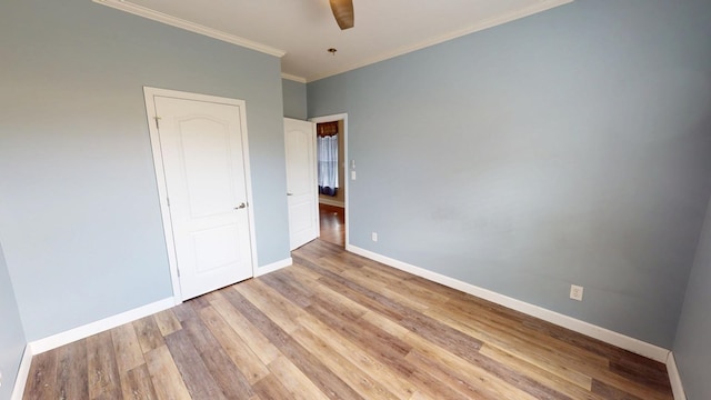 unfurnished bedroom featuring ornamental molding, ceiling fan, and light hardwood / wood-style flooring