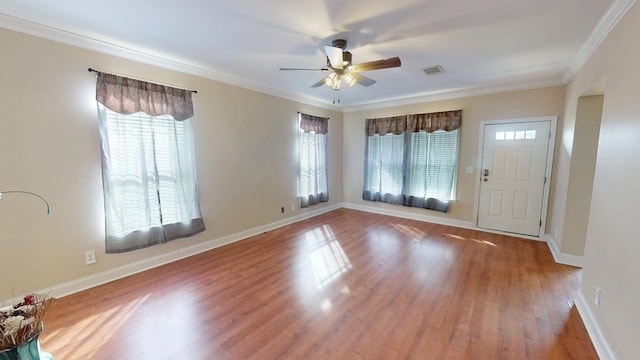 foyer featuring ornamental molding, wood-type flooring, and ceiling fan