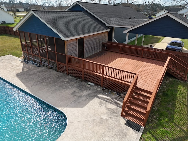 view of swimming pool featuring a wooden deck and a patio area