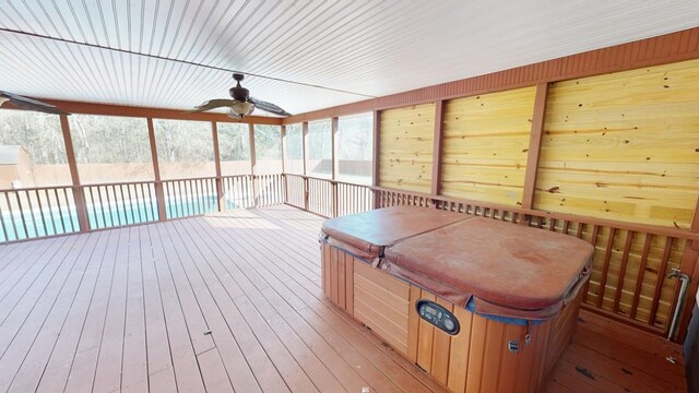 deck featuring ceiling fan and a pool with hot tub