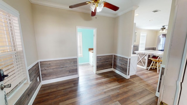 spare room with dark hardwood / wood-style flooring and crown molding