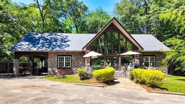 151 Lewis Rd, Cairo, GA 39828 - view of front of house with stone siding, driveway, and roof with shingles