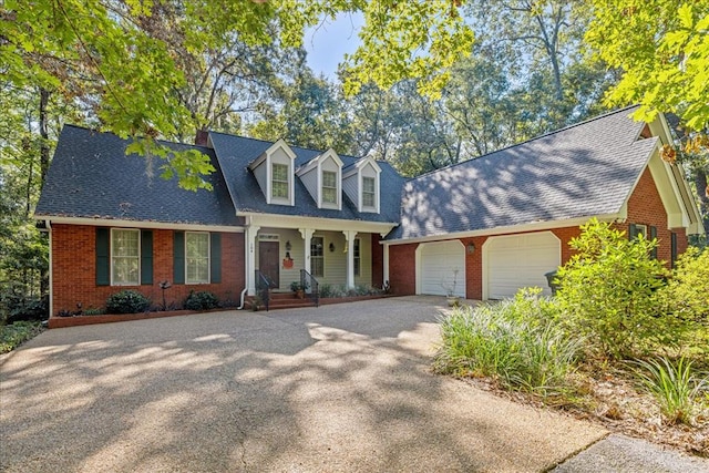 new england style home featuring a garage