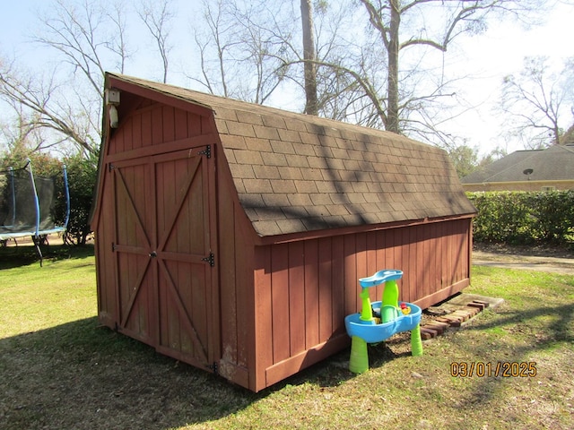 view of shed with a trampoline