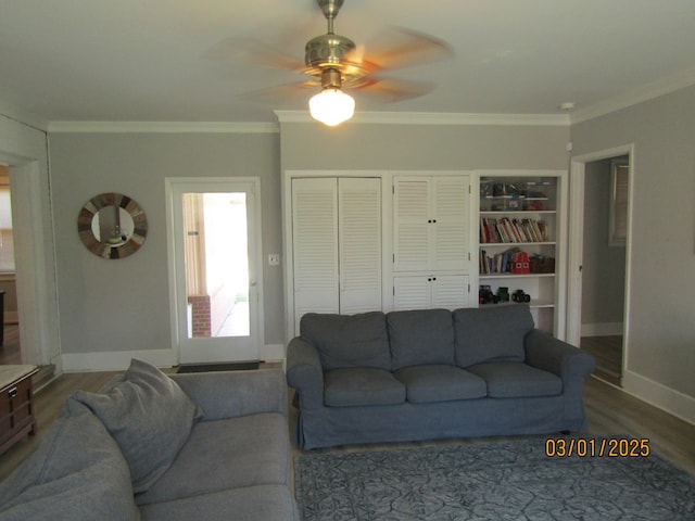 living room with baseboards, ornamental molding, ceiling fan, and wood finished floors