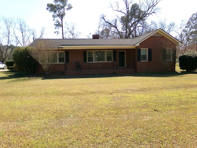 ranch-style house with brick siding, crawl space, a chimney, and a front lawn