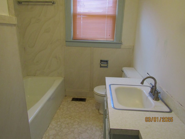 bathroom with visible vents, a tub to relax in, a sink, and toilet