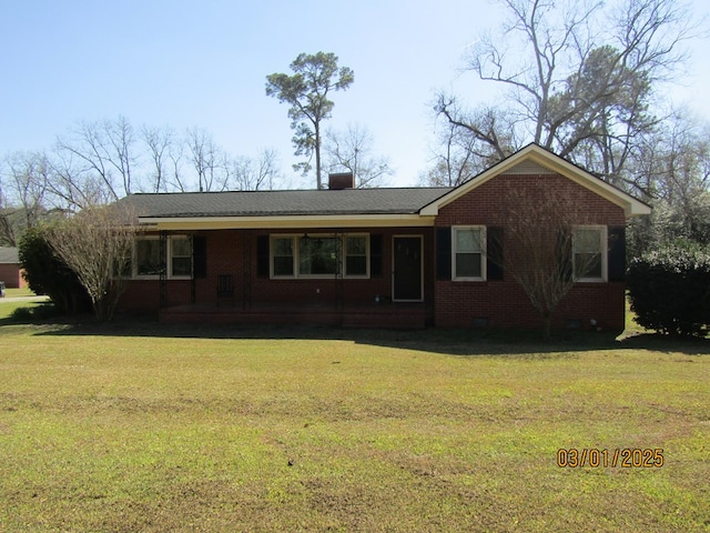 ranch-style home featuring brick siding, crawl space, a chimney, and a front lawn