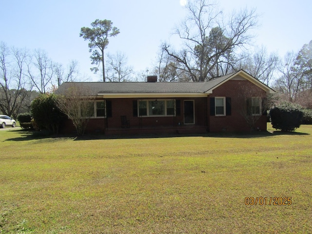 single story home with a front yard and brick siding