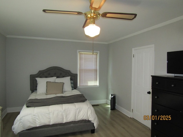 bedroom with ornamental molding, ceiling fan, baseboards, and wood finished floors