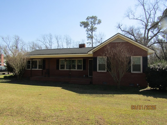 ranch-style house featuring brick siding, a chimney, crawl space, covered porch, and a front yard