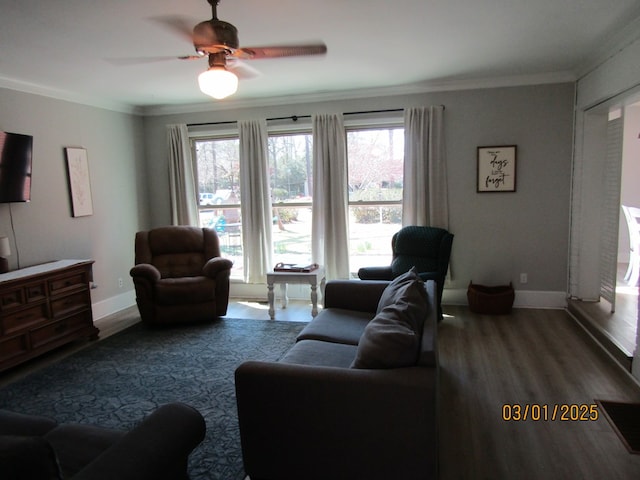 living room with ornamental molding, a wealth of natural light, baseboards, and wood finished floors