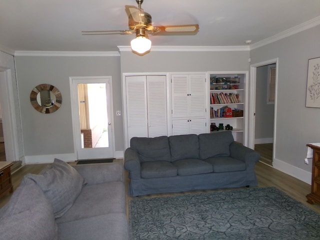 living area featuring ceiling fan, baseboards, crown molding, and wood finished floors