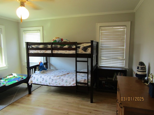 bedroom featuring wood finished floors and crown molding