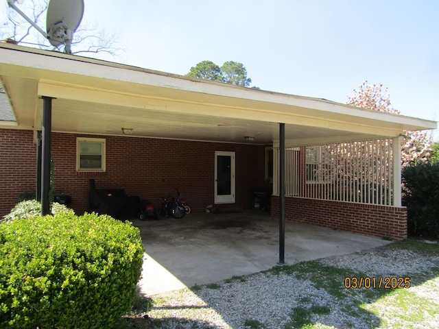 view of parking with driveway and a carport