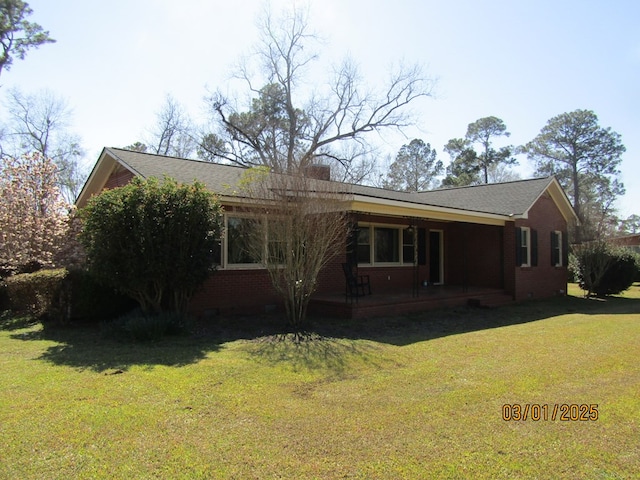 view of front of property with brick siding, crawl space, and a front yard