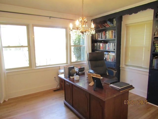 home office featuring a notable chandelier, light wood-style flooring, and baseboards