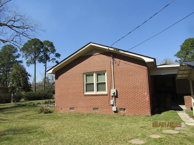 view of property exterior with crawl space, brick siding, and a yard