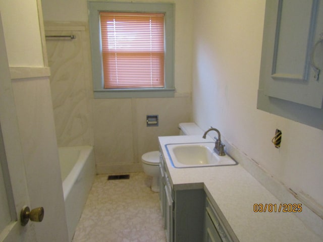 bathroom with visible vents, vanity, toilet, and tile patterned floors